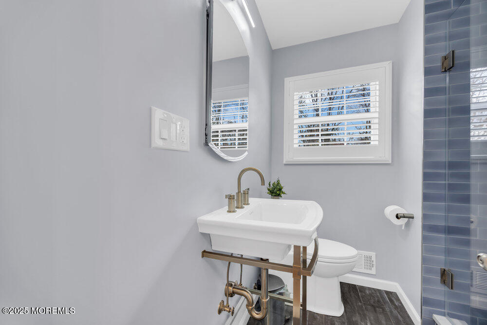 46 Owens Road Old Bridge, NJ 08857 - Photo 6 of 26 a bathroom with a sink a mirror and a toilet