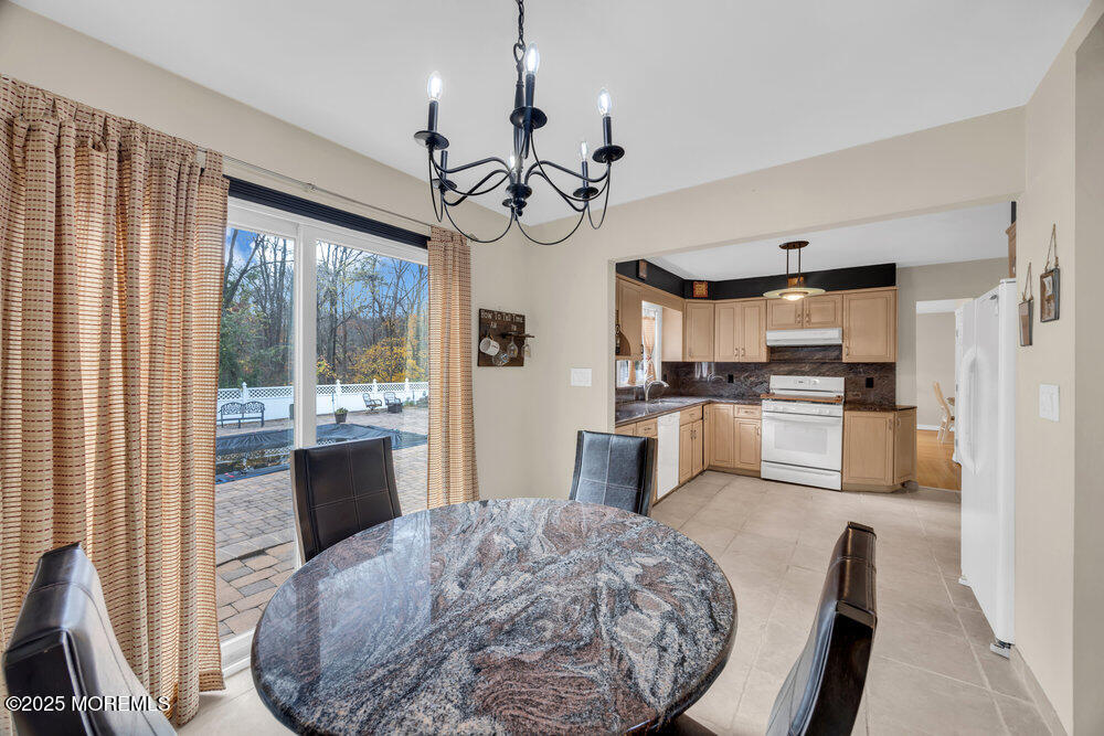 46 Owens Road Old Bridge, NJ 08857 - Photo 9 of 26 a kitchen view with stainless steel appliances granite countertop a stove a sink dishwasher a refrigerator white cabinets and wooden floor