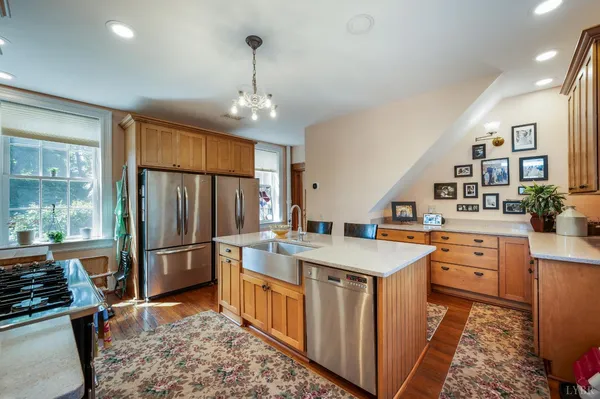 a spacious bedroom with a bed a fireplace and a flat screen tv