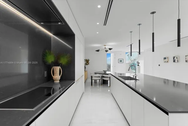 a large kitchen with kitchen island a large counter space a sink and appliances