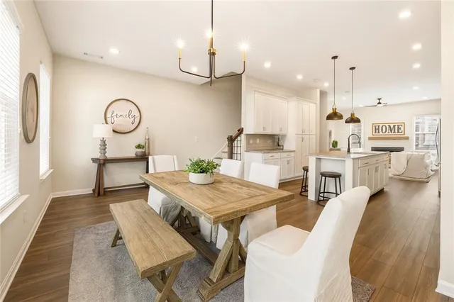 a living room with kitchen island furniture and a clock