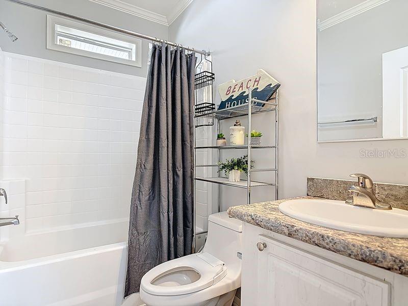 102 Ash Street Edgewater, FL 32141 - Photo 28 of 36 a bathroom with a granite countertop sink toilet and shower