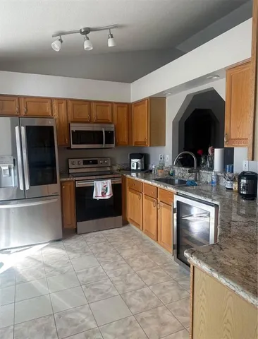 a kitchen with stainless steel appliances granite countertop a stove sink and microwave
