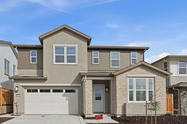a front view of a house with garage