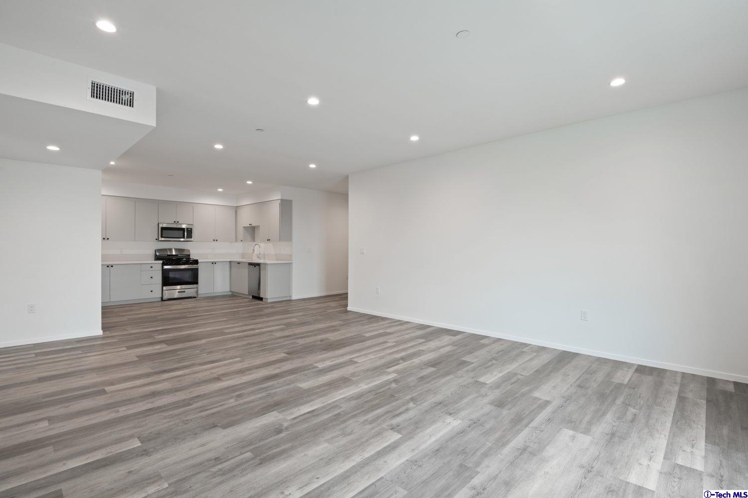 7064 Greeley Street, Unit 201 Tujunga, CA 91042 - Photo 11 of 34 a view of kitchen with kitchen island and wooden floor