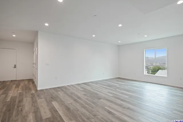 a view of a kitchen counter space a sink wooden floor and cabinets