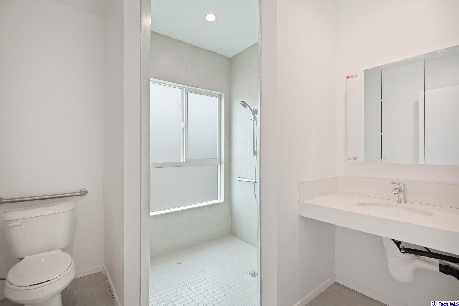 7064 Greeley Street, Unit 201 Tujunga, CA 91042 - Photo 20 of 34 a bathroom with a sink a toilet and shower