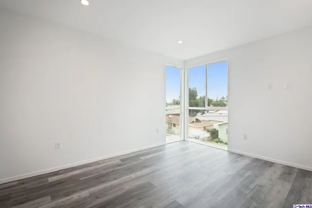 a view of hallway with wooden floor
