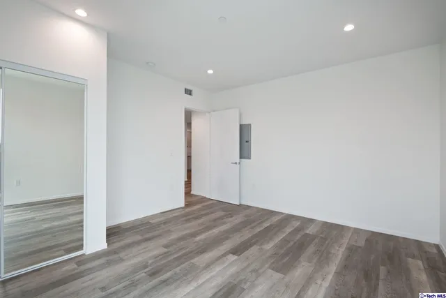 a view of empty room with wooden floor