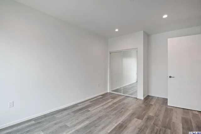 a view of a house with a yard and potted plants