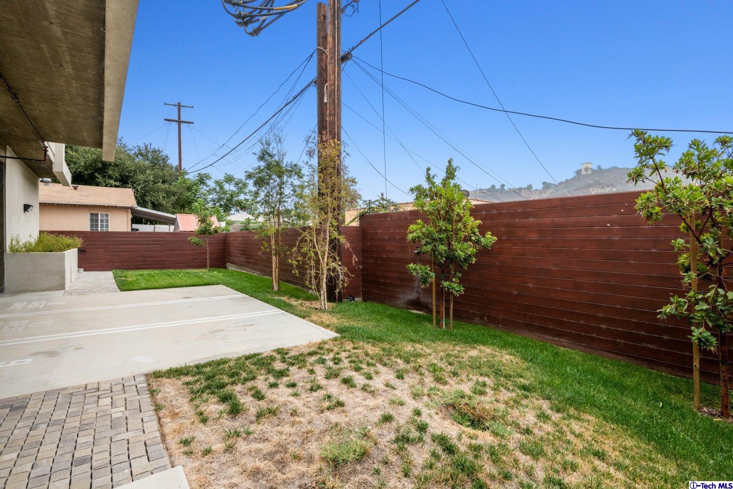 7064 Greeley Street, Unit 201 Tujunga, CA 91042 - Photo 28 of 34 a backyard of a house with lots of green space