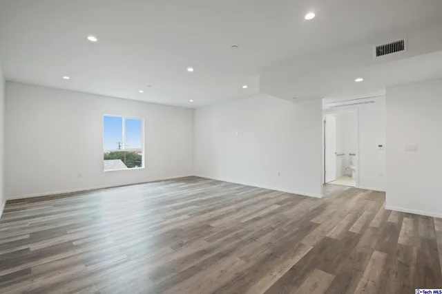 a view of kitchen with kitchen island and wooden floor