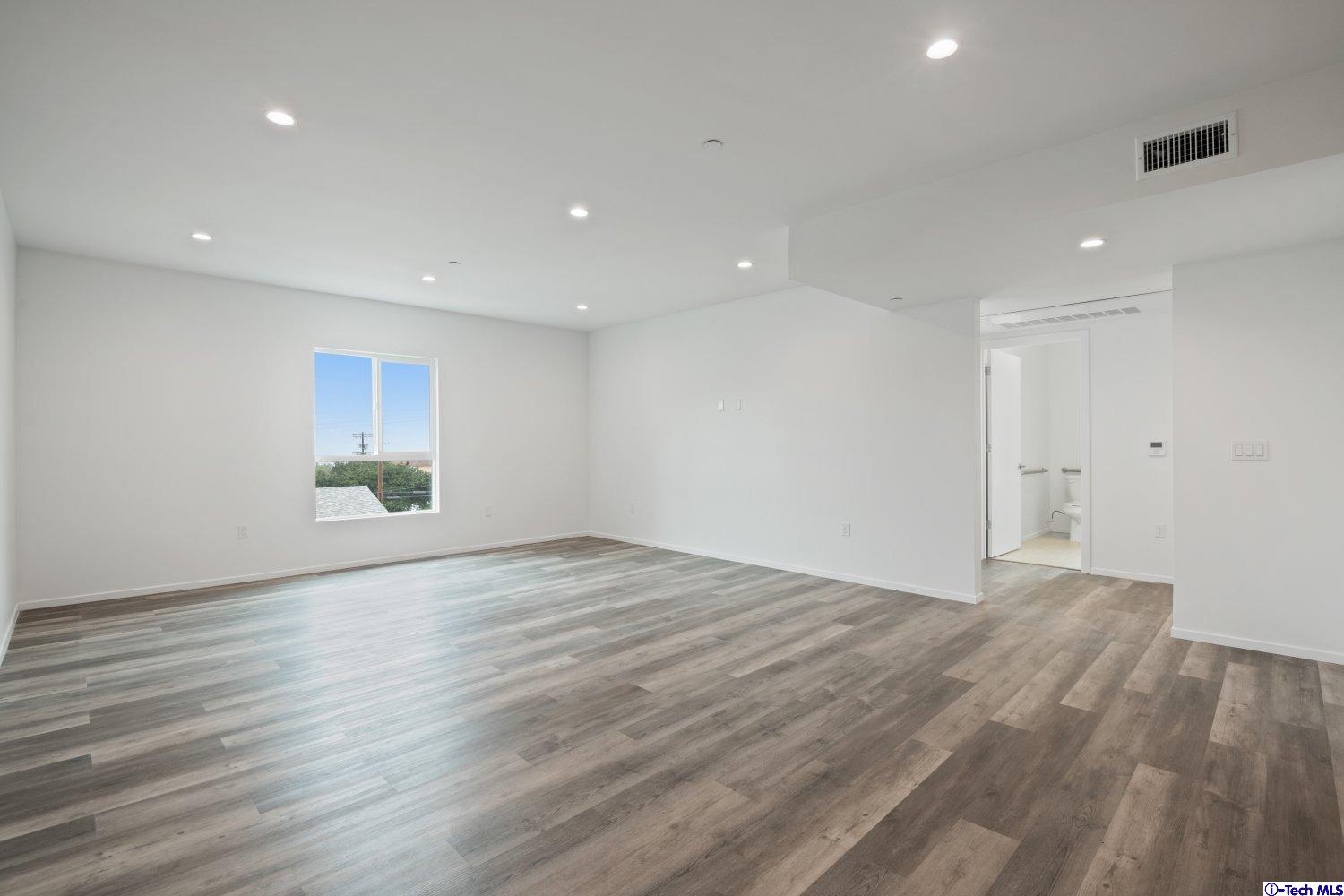 7064 Greeley Street, Unit 201 Tujunga, CA 91042 - Photo 9 of 34 a view of empty room with wooden floor