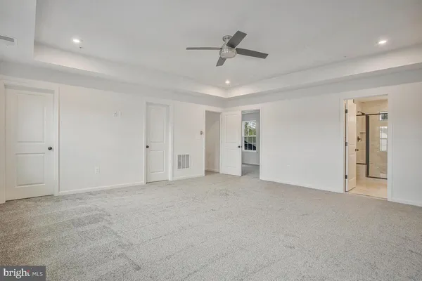 an empty room with windows and closet