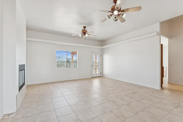 a view of a livingroom with wooden floor and a ceiling fan