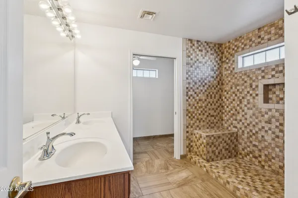 a view of a small space with wooden floor and a window
