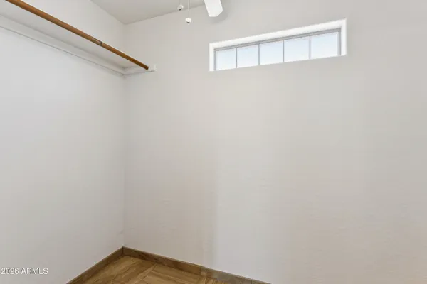 a view of a room with a ceiling fan