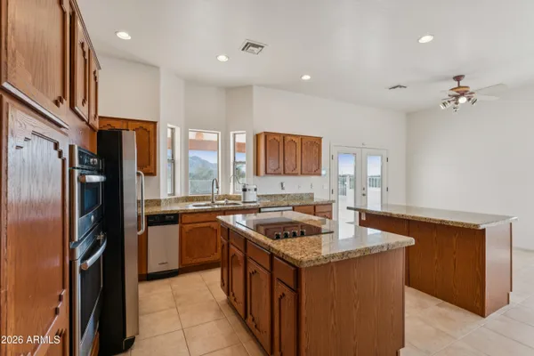 a kitchen with stainless steel appliances granite countertop wooden cabinets a sink and a stove