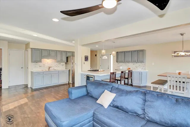 a living room with furniture and kitchen view