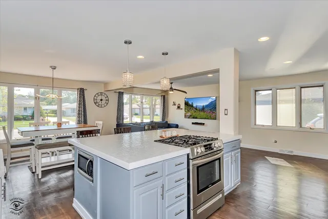a kitchen with stainless steel appliances a stove a sink and a microwave