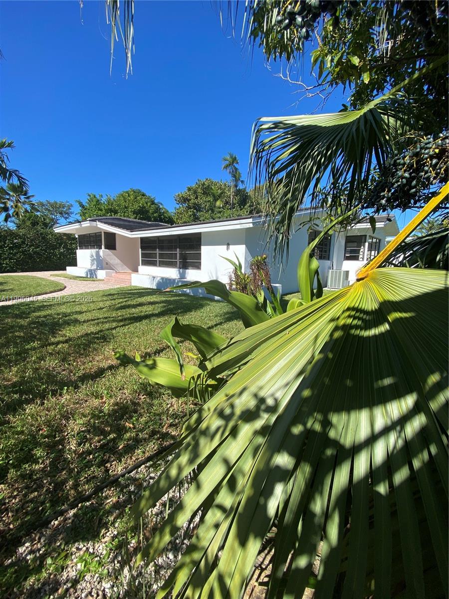 1101 Bay Drive Miami Beach, FL 33141 - Photo 12 of 69 a front view of a house with a yard