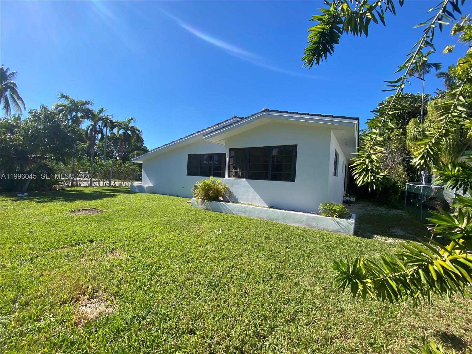 1101 Bay Drive Miami Beach, FL 33141 - Photo 15 of 69 a front view of a house with garden
