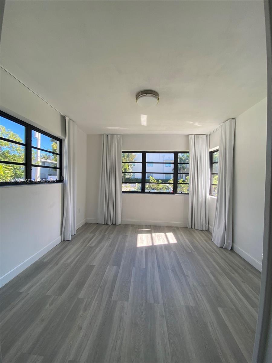 1101 Bay Drive Miami Beach, FL 33141 - Photo 39 of 69 wooden floor in an empty room with a window