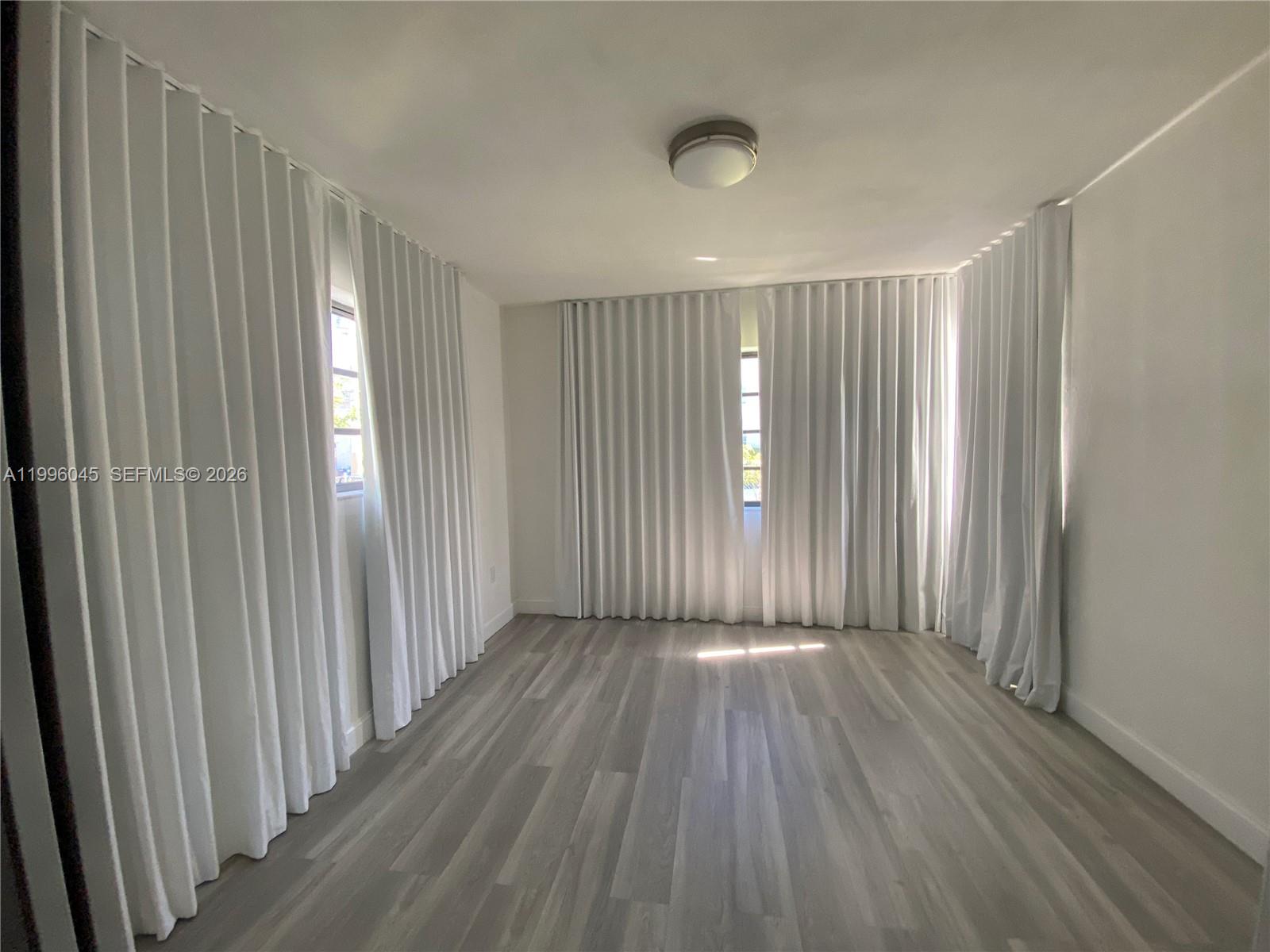 1101 Bay Drive Miami Beach, FL 33141 - Photo 41 of 69 a view of a room with wooden floor