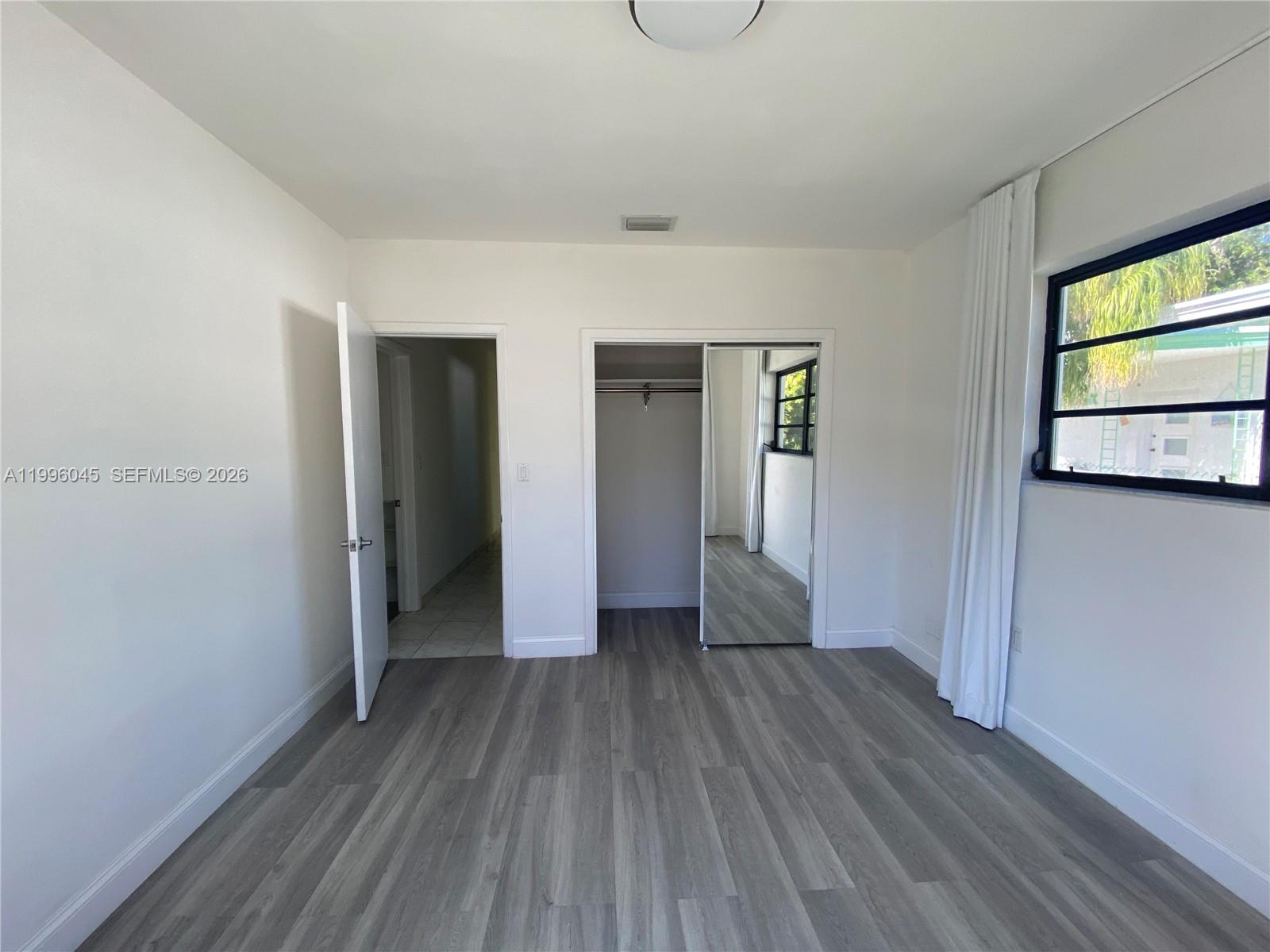 1101 Bay Drive Miami Beach, FL 33141 - Photo 46 of 69 a view of hallway with bathroom and wooden floor
