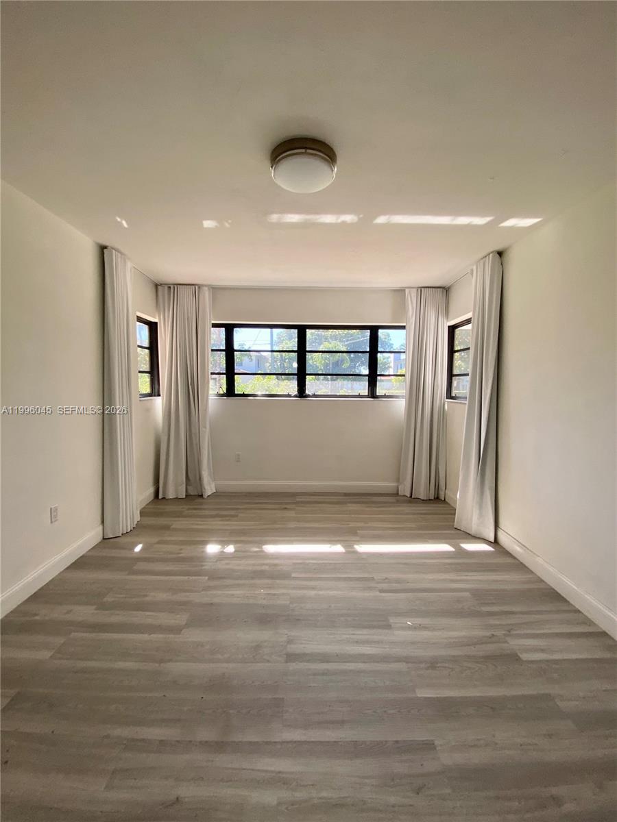 1101 Bay Drive Miami Beach, FL 33141 - Photo 57 of 69 a view of empty room with wooden floor and fan