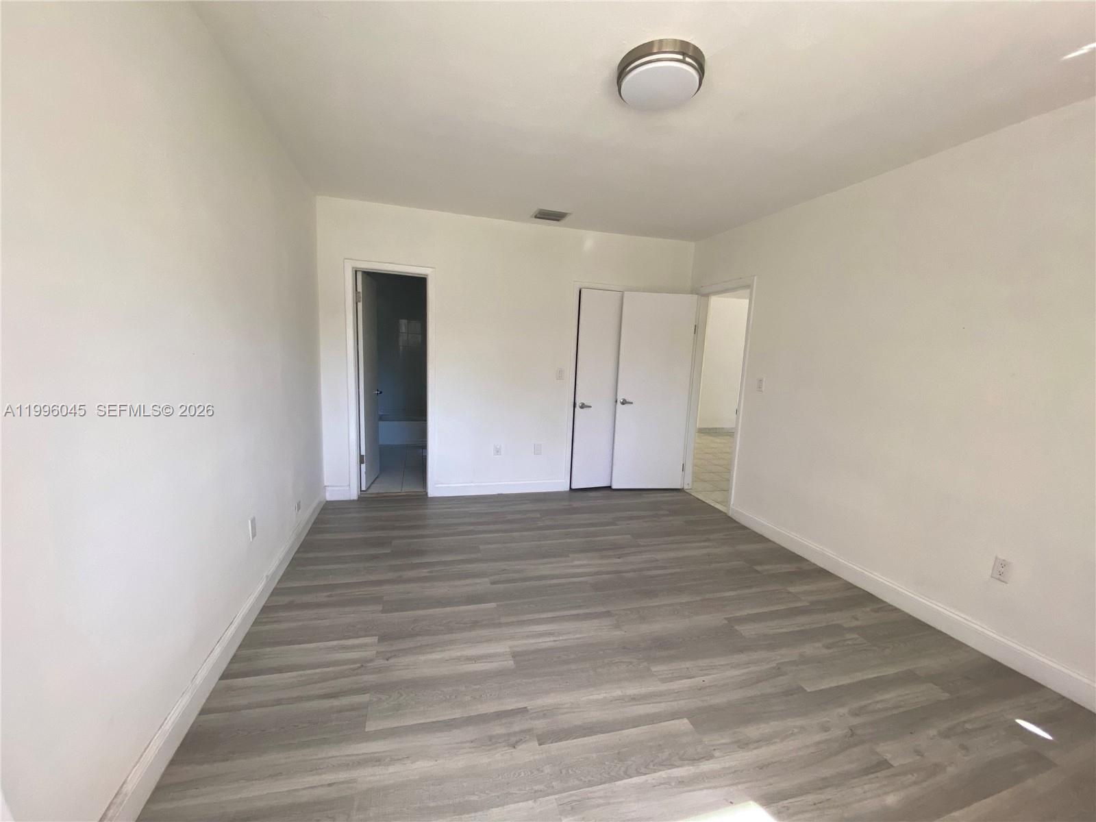 1101 Bay Drive Miami Beach, FL 33141 - Photo 59 of 69 a view of a room with wooden floor and white walls