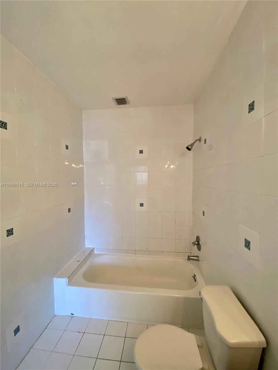 1101 Bay Drive Miami Beach, FL 33141 - Photo 65 of 69 a bathroom with a vanity bathtub and toilet