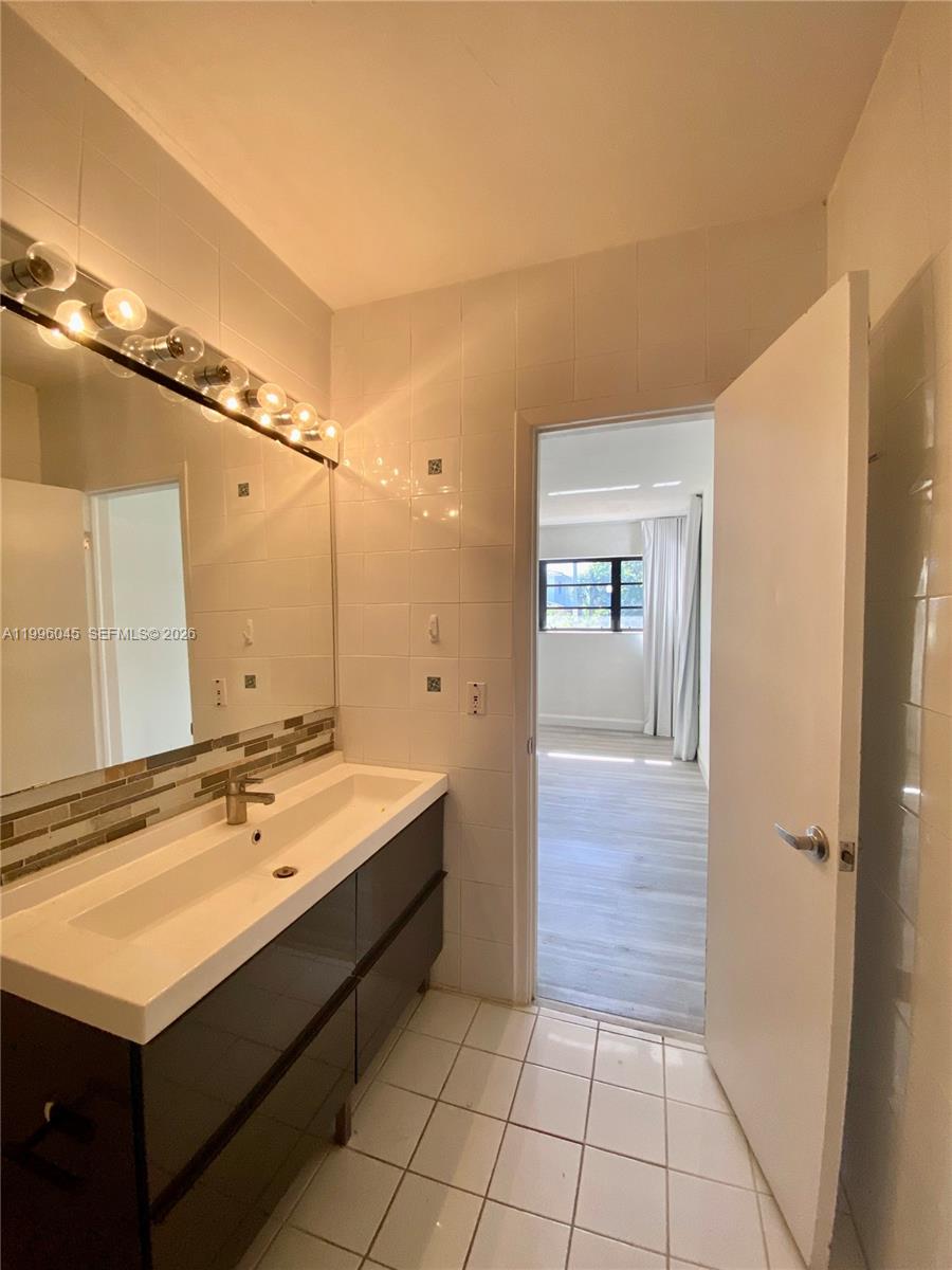 1101 Bay Drive Miami Beach, FL 33141 - Photo 67 of 69 a bathroom with a sink and a mirror