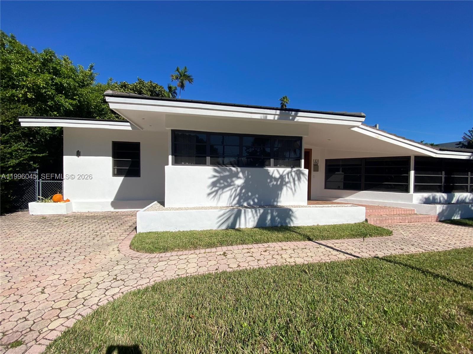 1101 Bay Drive Miami Beach, FL 33141 - Photo 9 of 69 a front view of a house with a yard