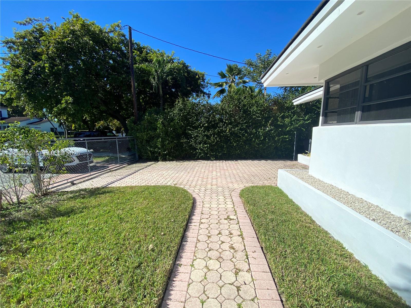 1101 Bay Drive Miami Beach, FL 33141 - Photo 10 of 69 a view of swimming pool with a garden