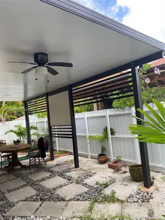 a view of a porch with furniture and floor to ceiling window