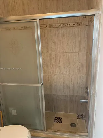 a bathroom with a shower and a toilet