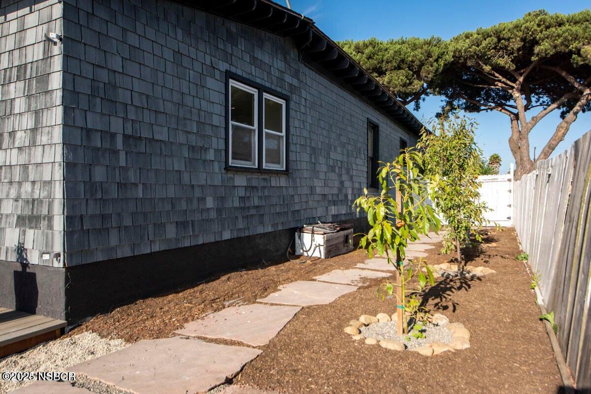 215 South H Street Lompoc, CA 93436 - Photo 22 of 24 a potted plant sitting in front of a brick house