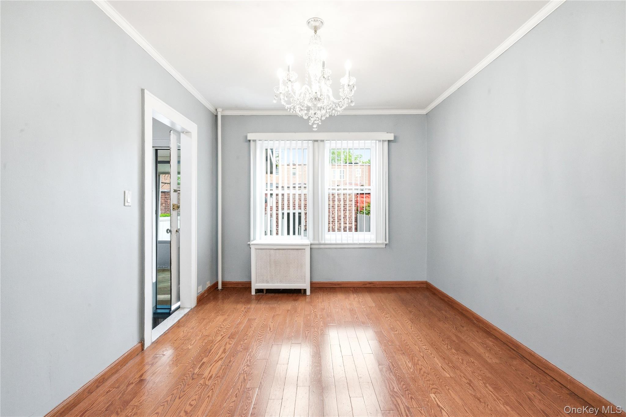 67-99 Exeter Street Queens, NY 11375 - Photo 9 of 28 wooden floor in an empty room with a window