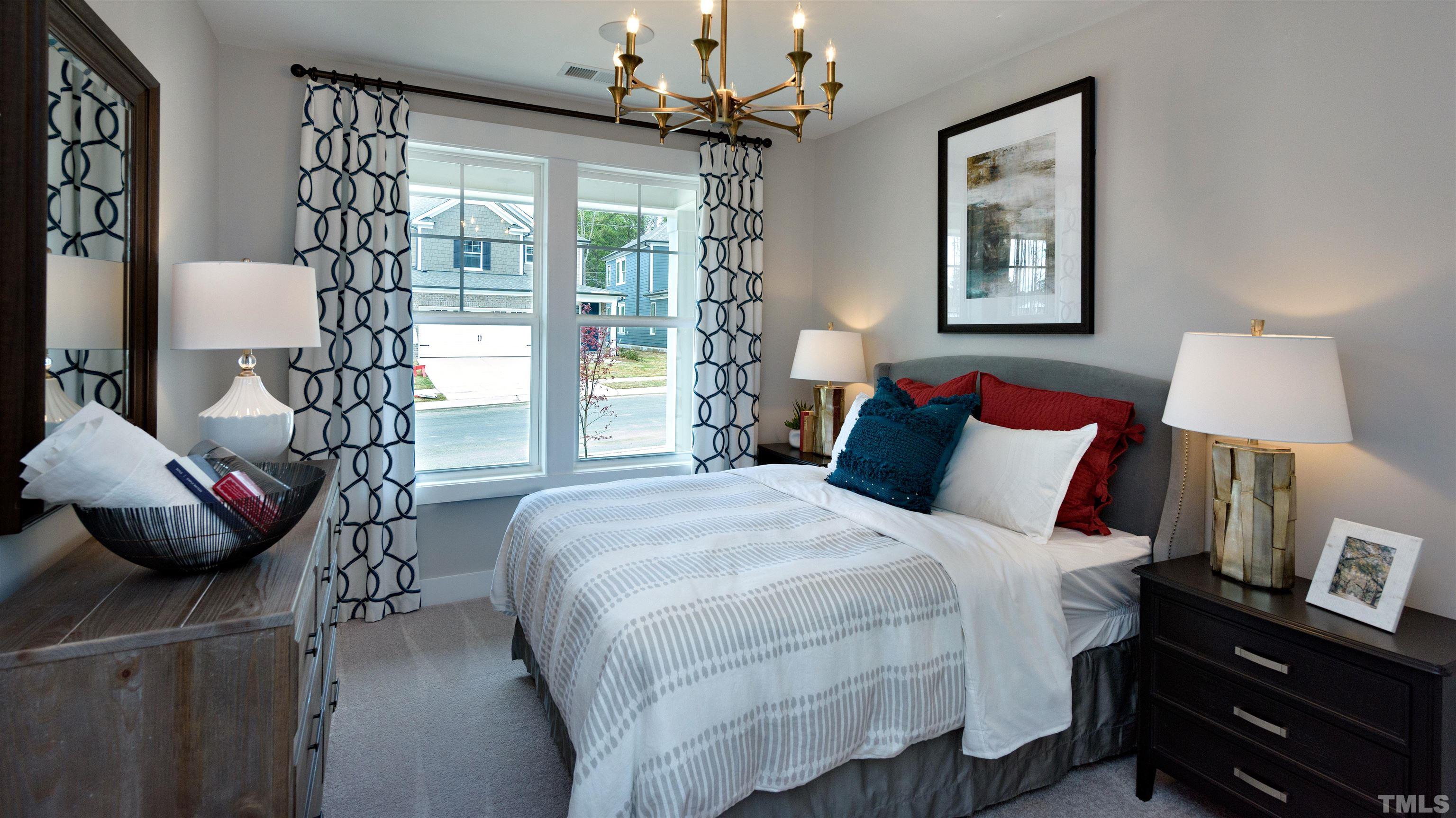 3255 Lynn Road, Unit 15 Raleigh, NC 27613 - Photo 6 of 21 a bedroom with a bed and a chandelier