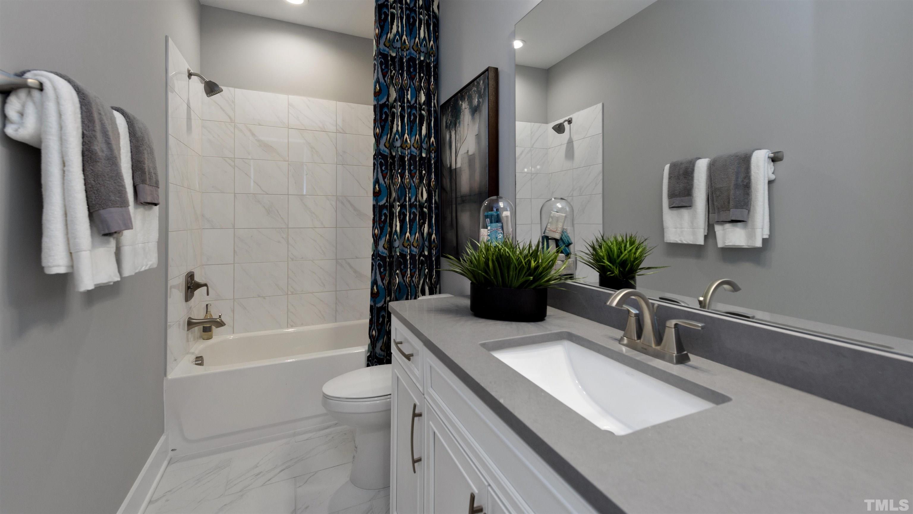 3255 Lynn Road, Unit 15 Raleigh, NC 27613 - Photo 7 of 21 a bathroom with a sink a toilet a tub and shower