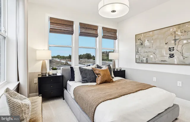 a bedroom with a bed and a painting on the wall