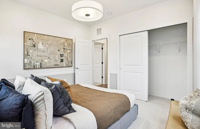 a bedroom with a large bed and a window