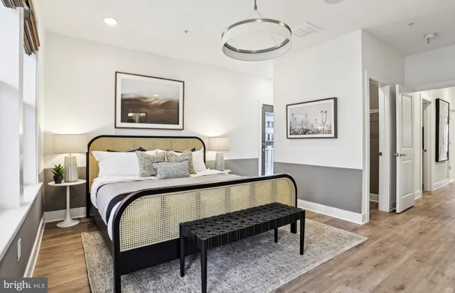 a kitchen that has a lot of cabinets in it and wooden floors