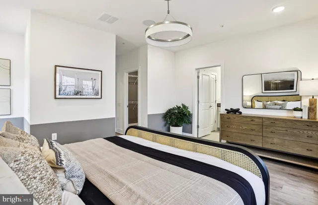 a bedroom with a bed and a large window