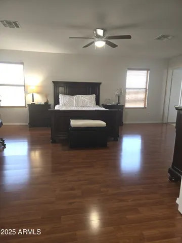 a spacious bedroom with a bed and a chandelier
