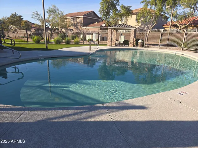a view of a street with a house in the background