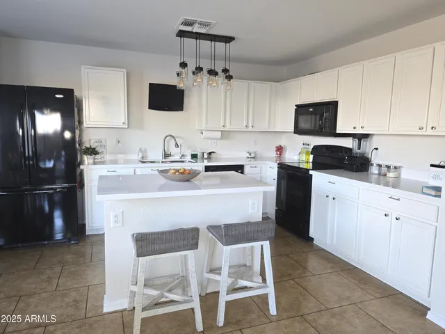 a kitchen with a sink stove and refrigerator