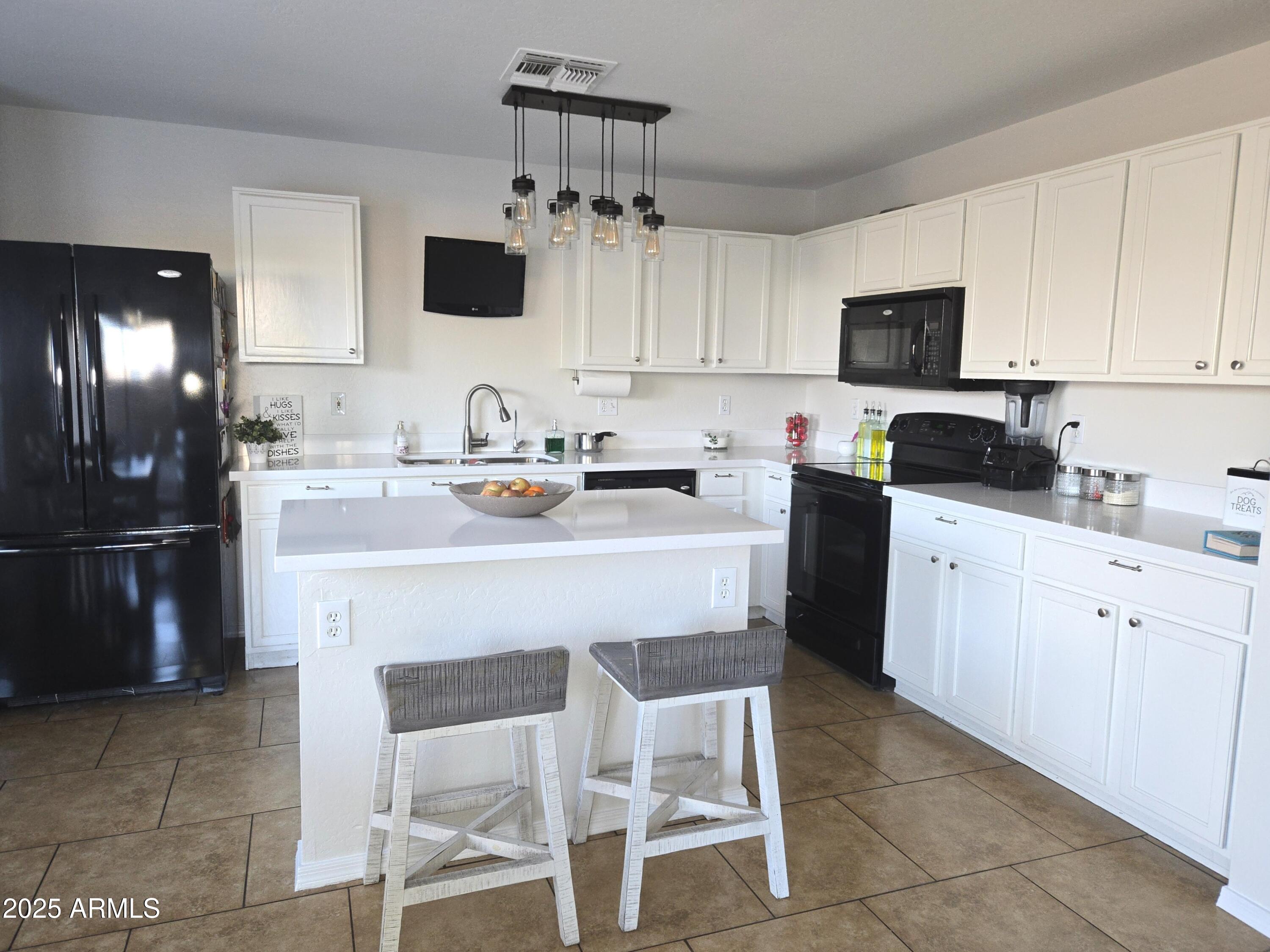 3283 South Conestoga Road Apache Junction, AZ 85119 - Photo 5 of 32 a kitchen with a sink stove and refrigerator