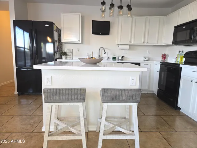 a kitchen with a sink cabinets and stainless steel appliances
